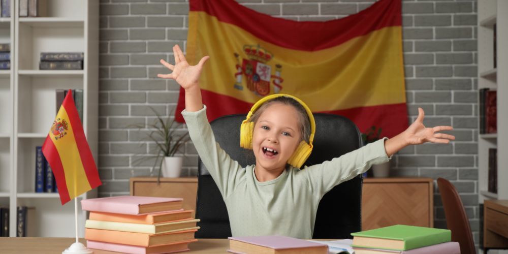 Photo of girl at a desk with a flag from Spain