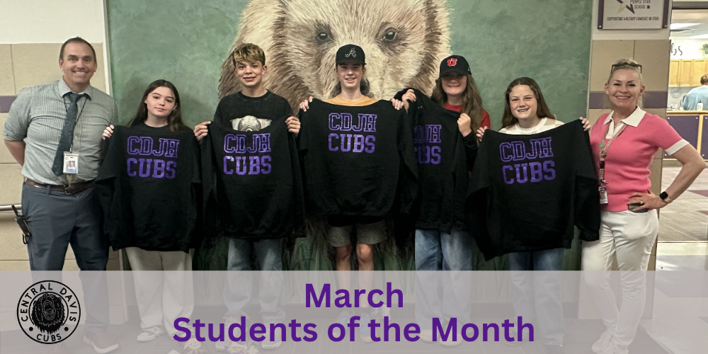 March Students of the Month standing together holding sweatshirts