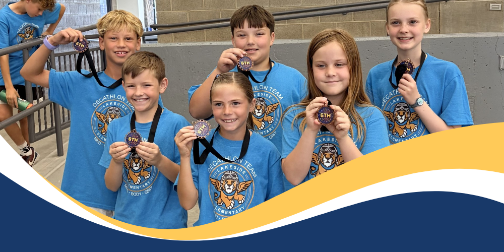 Students pose for a picture holding medals they won at the decathlon. 