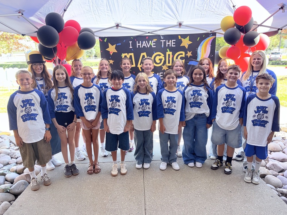 East Layton Elementary 2026 Student Council with their advisors standing in front of a sign that reads, "I have the magic in me," which is the school's theme for this academic school year. There are black and red balloons on each side of the sign that the students are standing in front of.