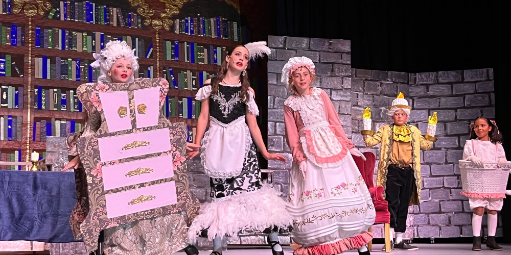 Bountiful Elementary Students preform on stage in coloful muical theater costumes in last year's Spring musical Beauty and the Beast Jr,