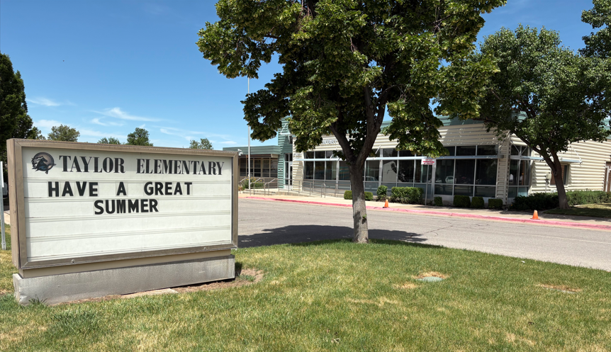 Have a Great Summer sign in front of exterior of Taylor Elementary School