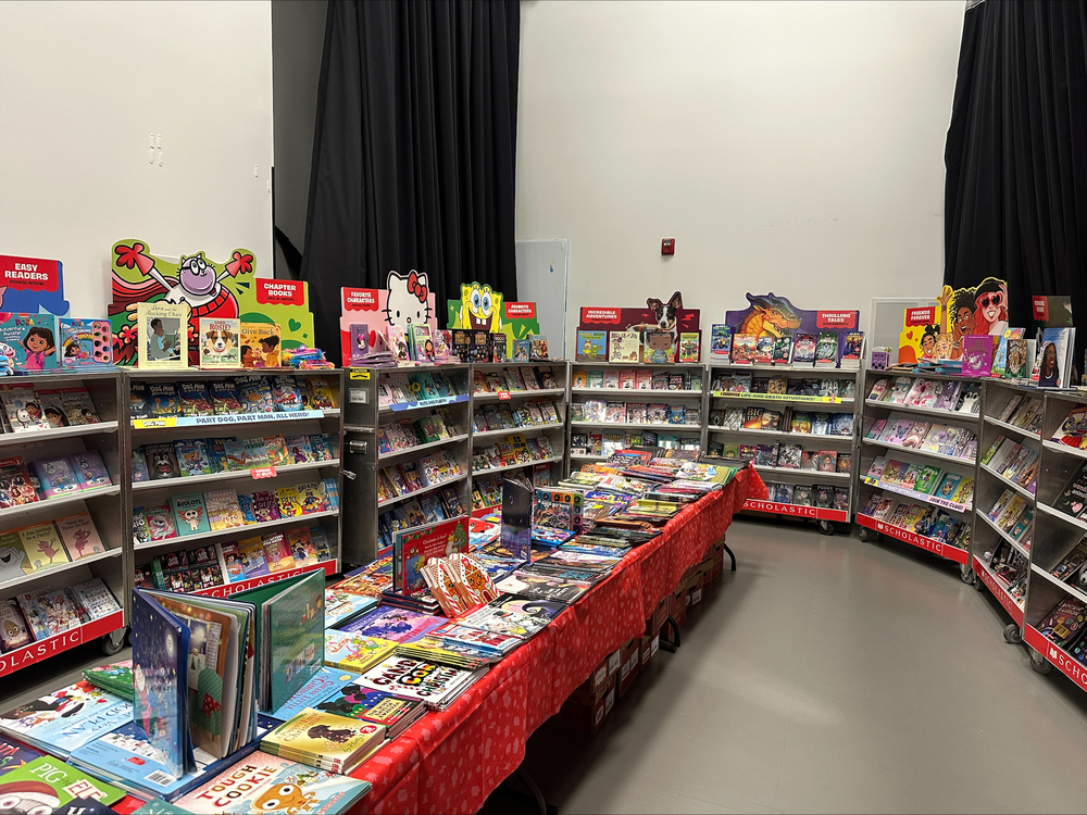 Book fair set up with books on shelves and tables.