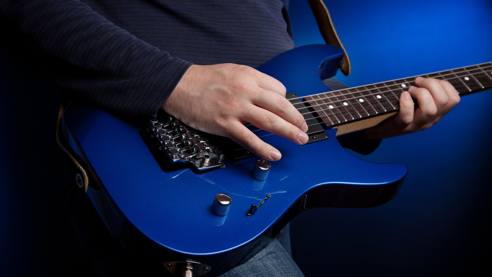 person playing electric guitar