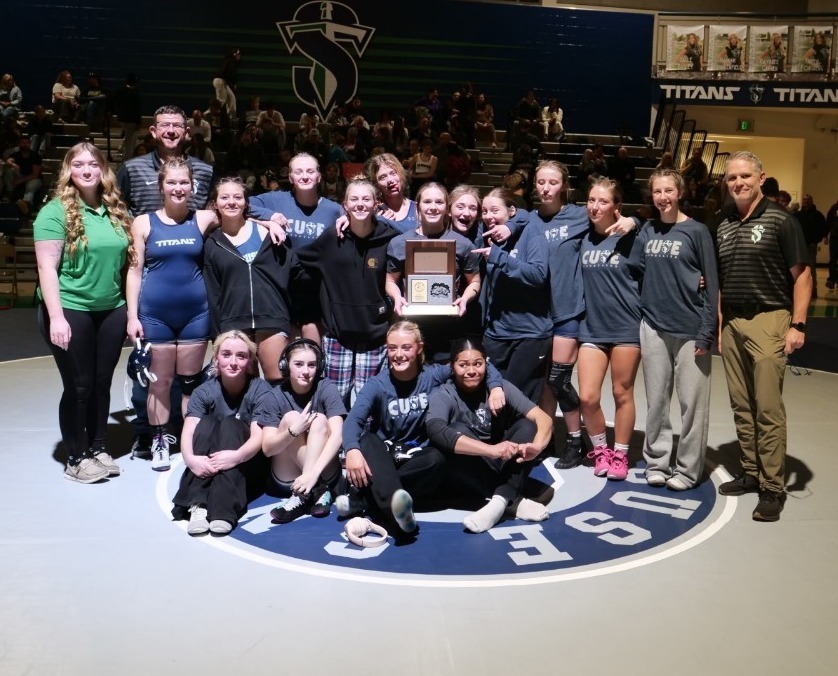 Girls wrestling team picture after winning region