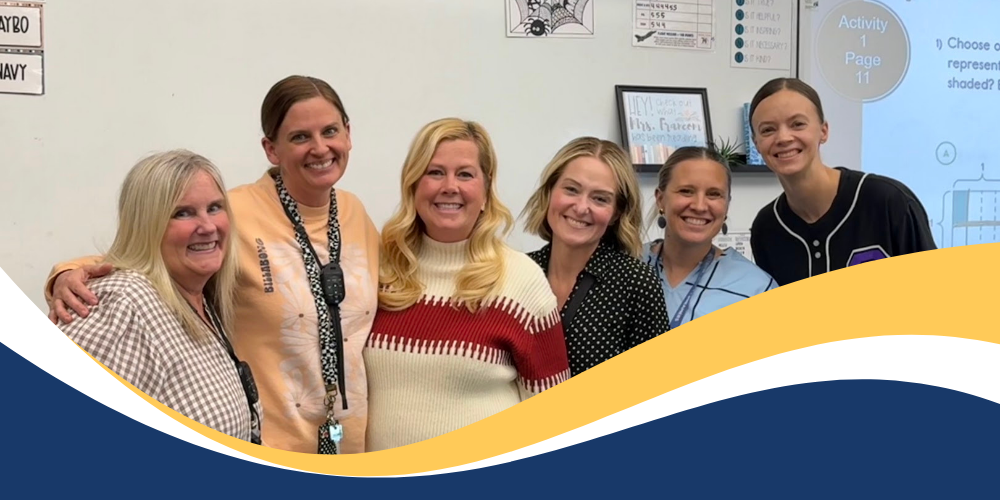 Mrs. Francom standing with fellow techers and students as she accepts an award. 