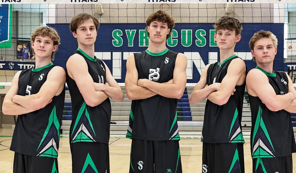picture of the 5 boys volleyball seniors for 2026 folding their arms by the net