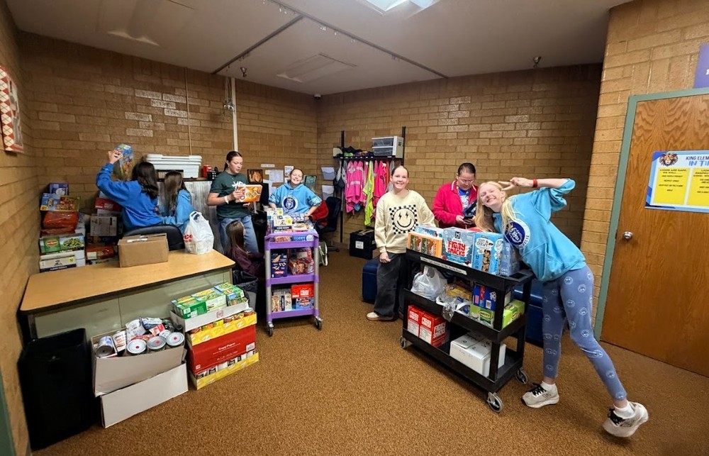 students loading collected food to donate