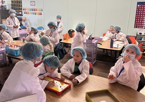 1st grade students in Mrs. Van Orman's class dressed up as doctors playing operation