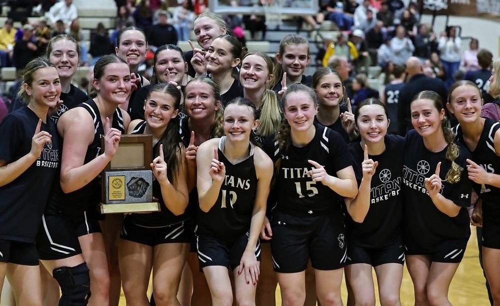girls basketball team picture with region championship trophy