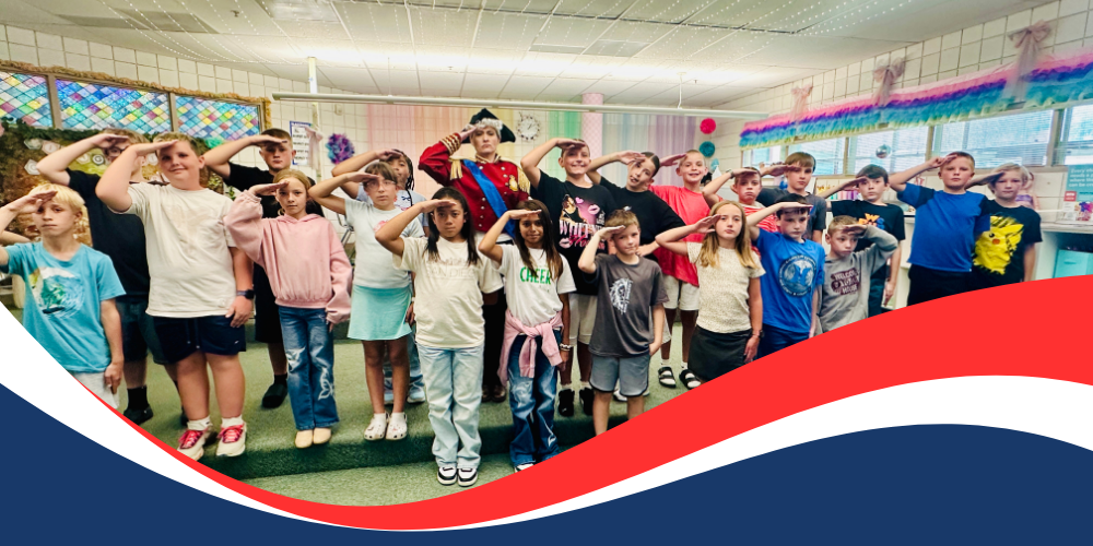 Students and Principal salute for a photo.