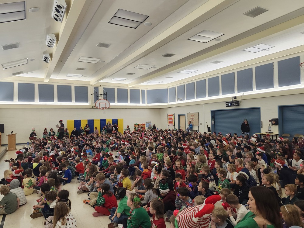 Students sitting in the cafeteria for the christmas singalong.