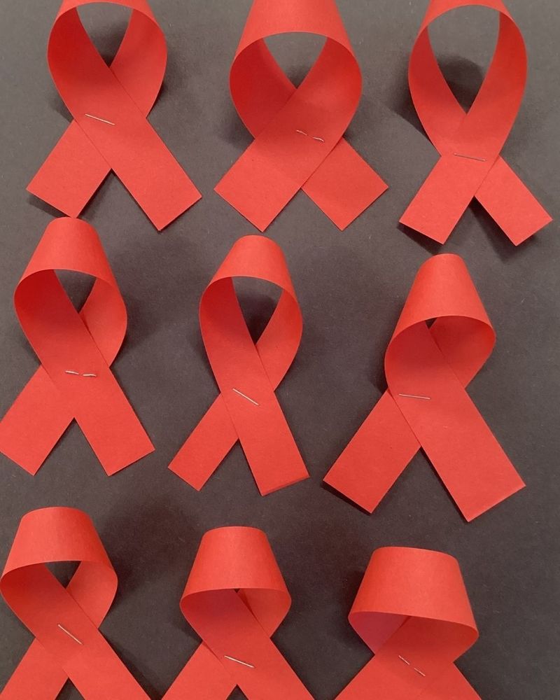 Six red paper ribbons on a black background.