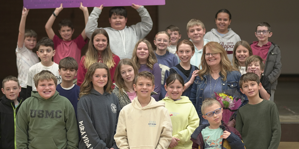 Students smiling with their teacher.