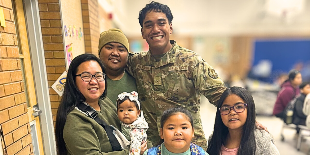 Family of 6 posing in the school cafeteria