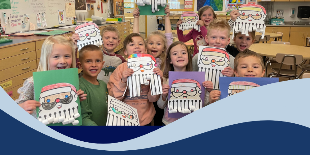 Students holding santa art