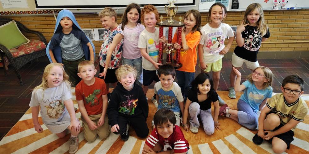 Students holding a trophy
