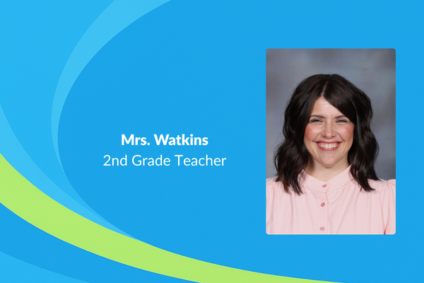 Mrs.  Watkins 2nd grade teacher photo of women with dark shoulder length wavy hair and pink shirt