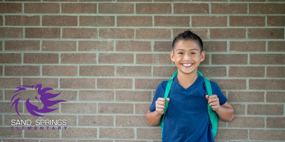 Student in front of brick wall