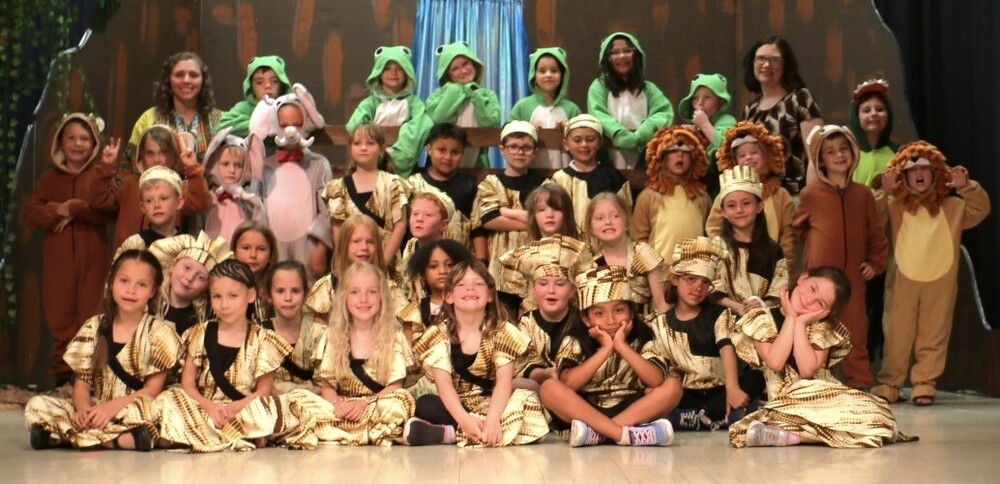 1st grade students dressed up in fun culture appropriate clothing for their African folk tale play the wide mouth frog