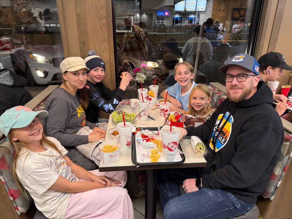 Family seated around table eating dinner