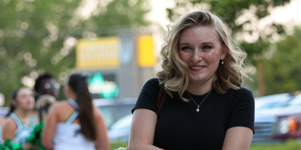 A teacher smiles as she walks into a school.