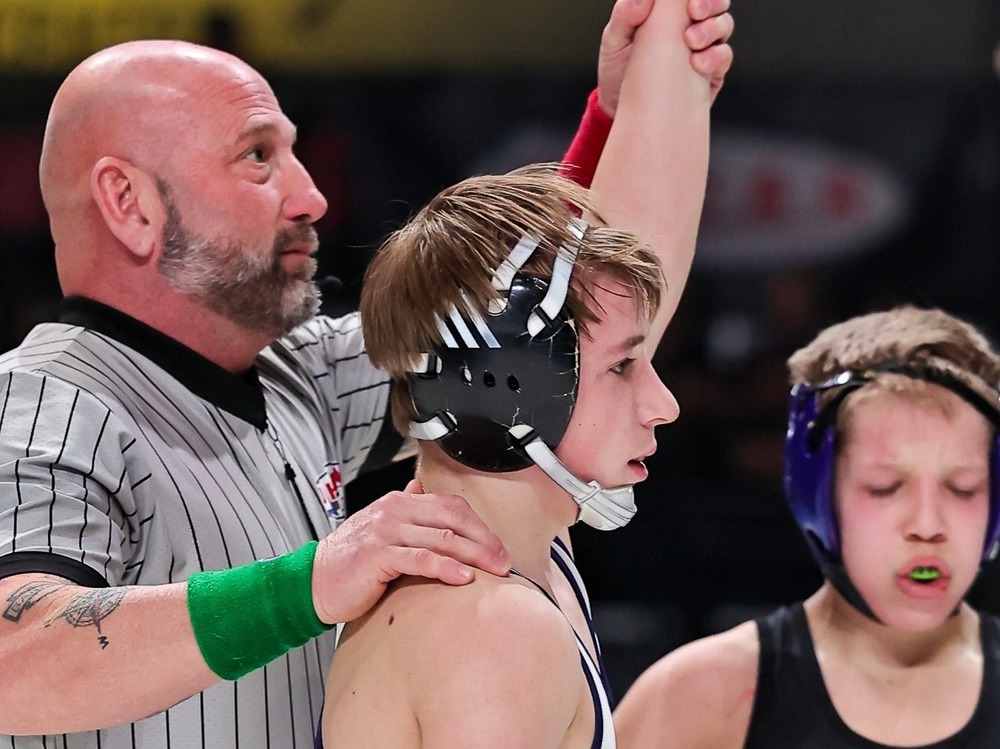 Reid Harris getting arm raised after winning wrestling state title