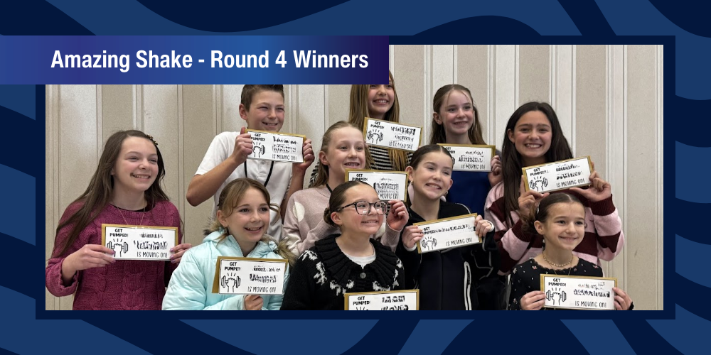 Students pose for picture holding winning envelopes.