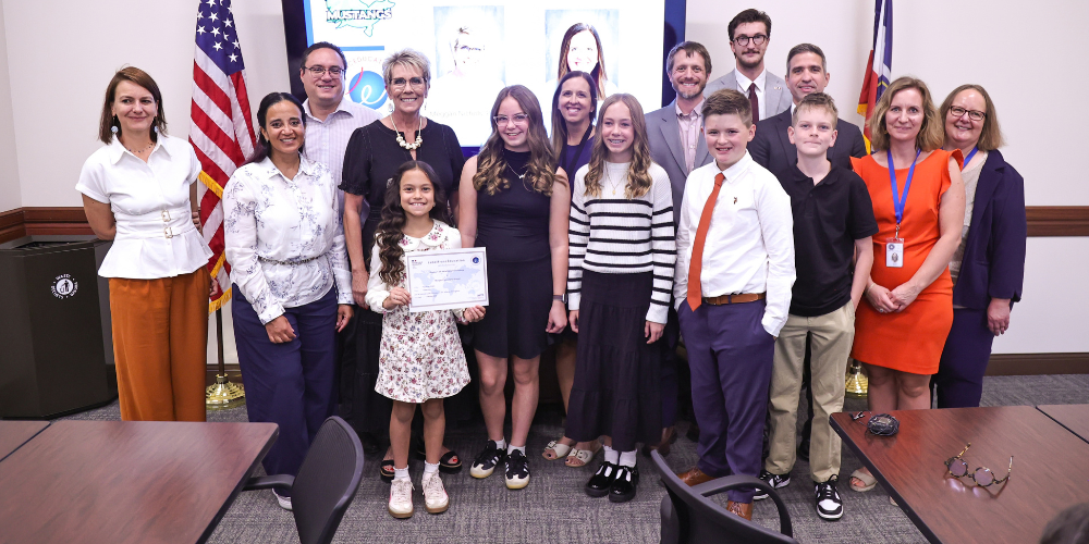 French immersion students and adults smiling with their recognition.