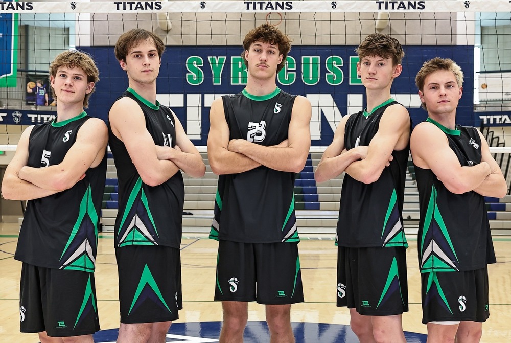 picture of the 5 boys volleyball seniors for 2026 folding their arms by the net