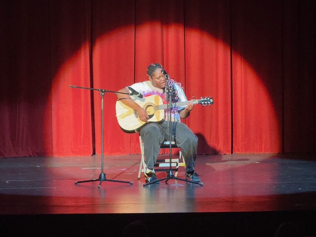 student playing the guitar