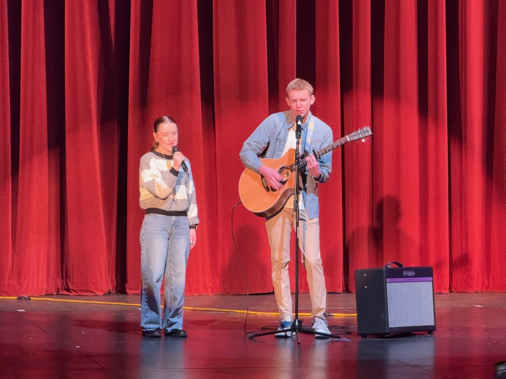 students singing with guitar