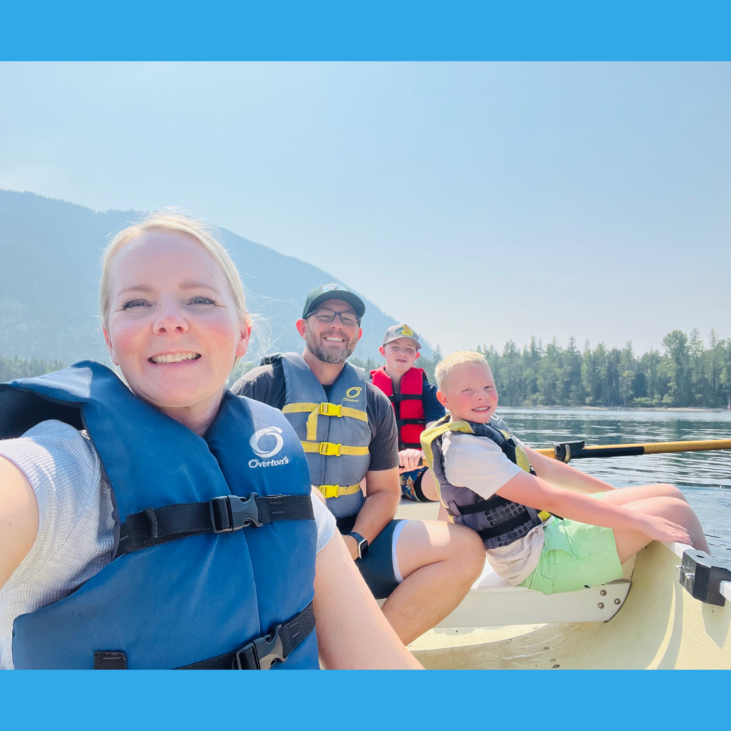 Photograph of Heather Bushnell and her family on a boat on a lake.