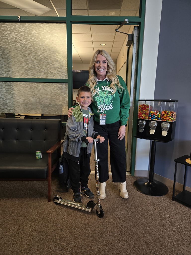 student and principal standing with scooter