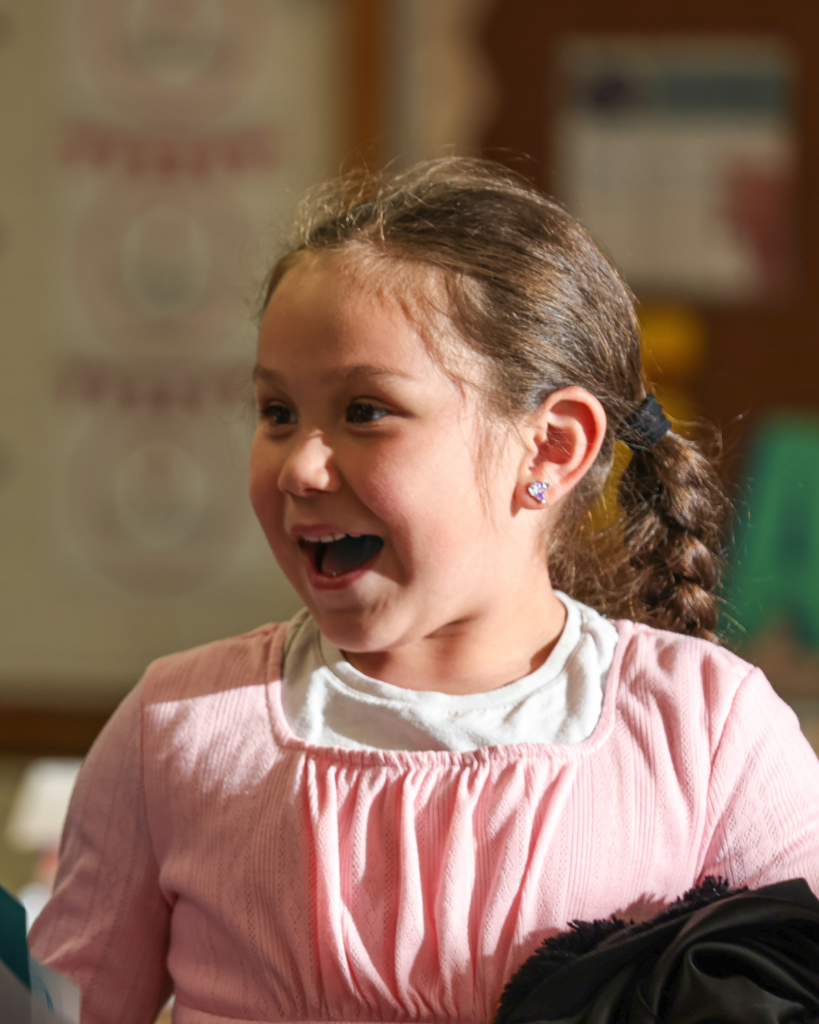 A student smiles to the left.