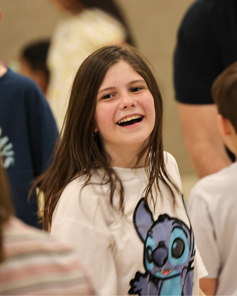 a student smiles at the camera.