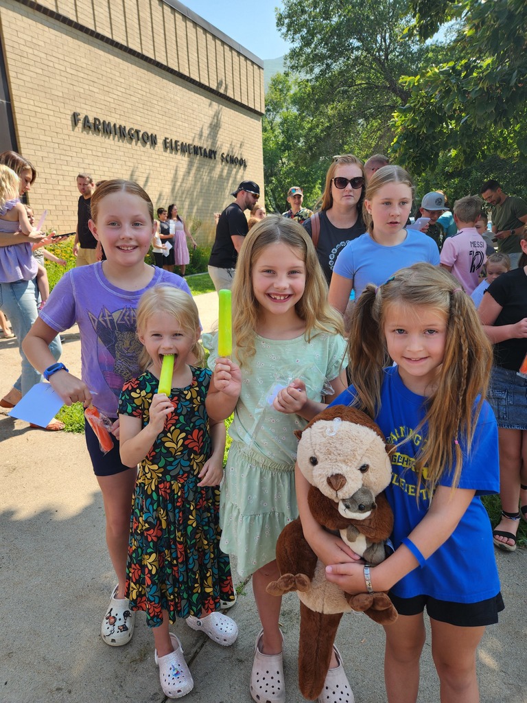 Students with popsicles greeting friends at popsicles with the principal event.