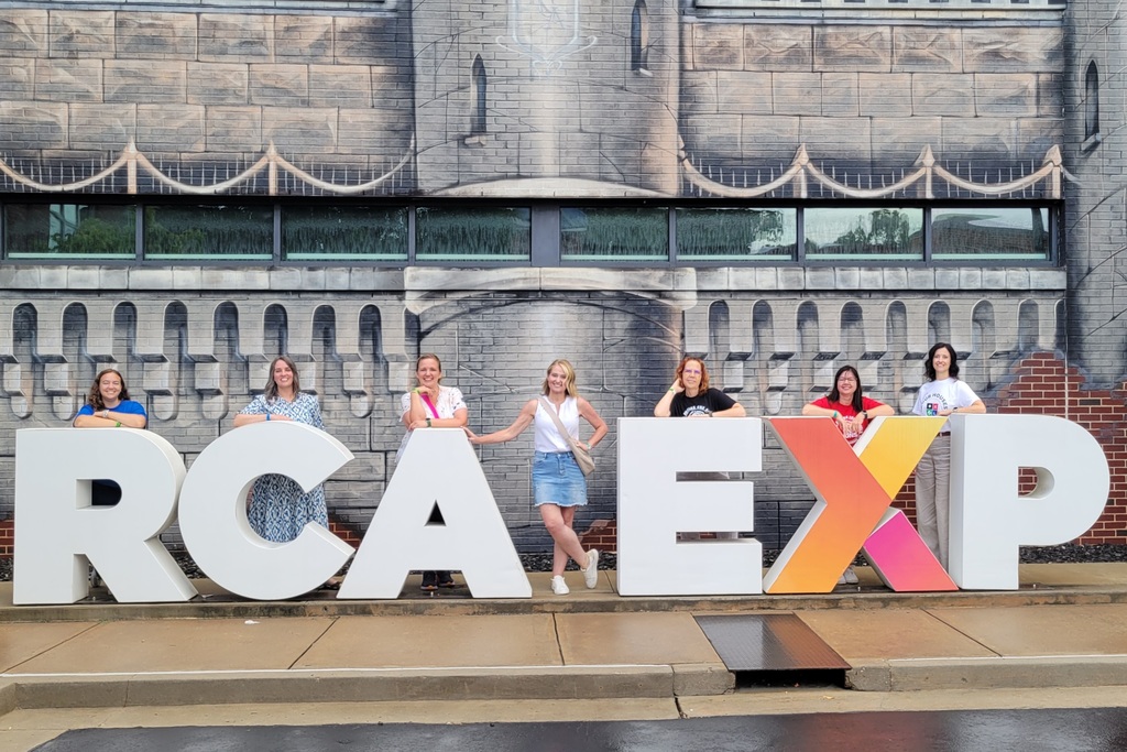 Lakeside staff members standing next to the letters "R,C,A,E,X,P" at the Ron Clark Academy in Atlanta, Georgia.