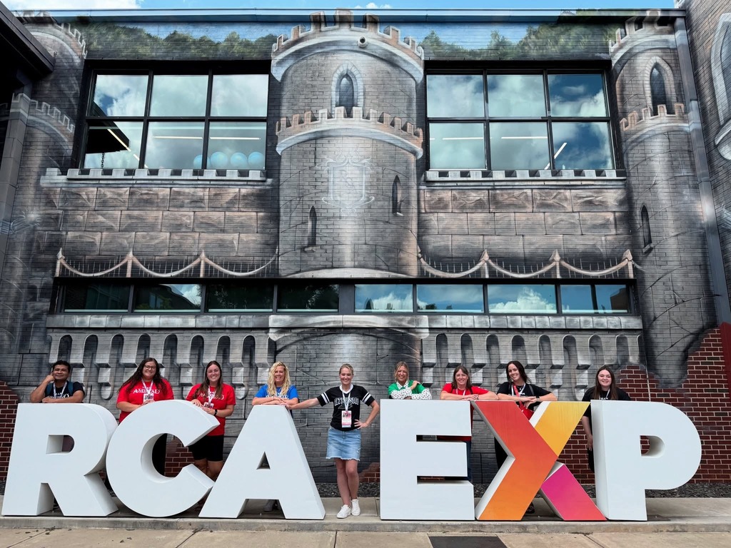 Lakeside staff members standing next to the letters "R,C,A,E,X,P" at the Ron Clark Academy in Atlanta, Georgia