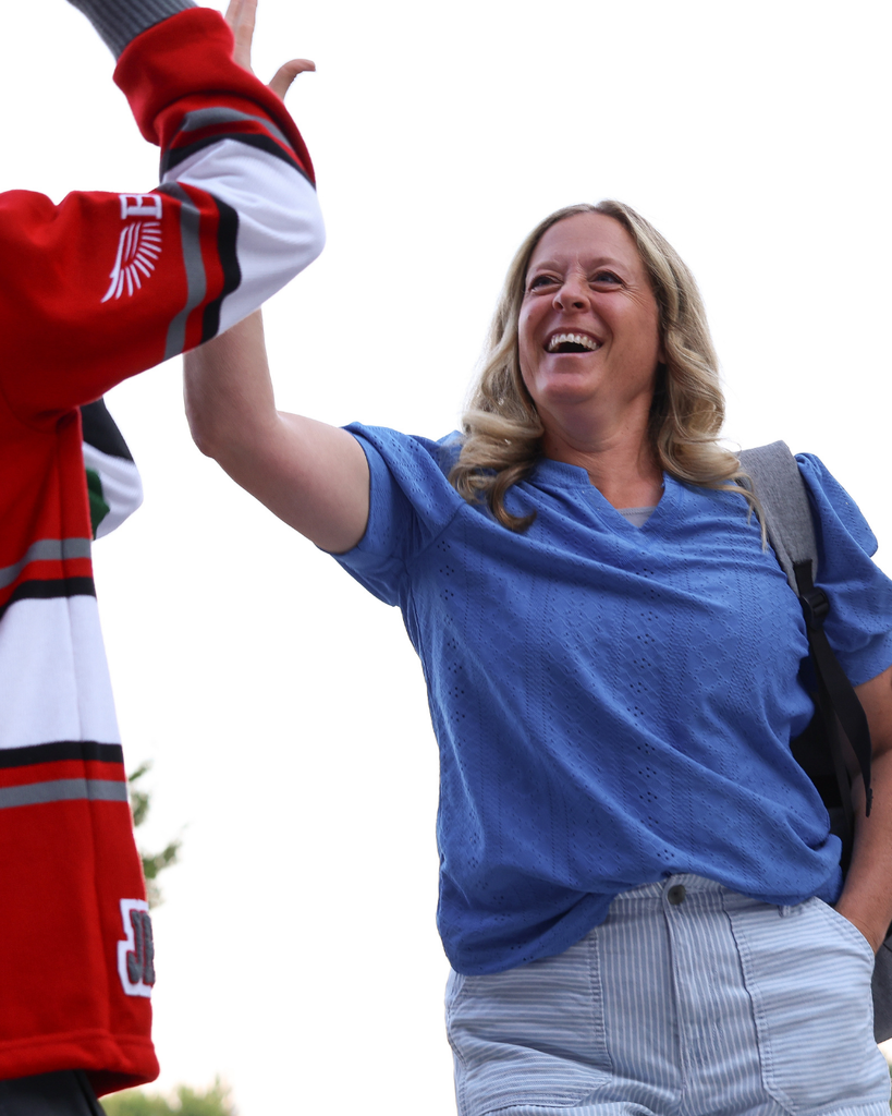 A teacher high-fiving a student