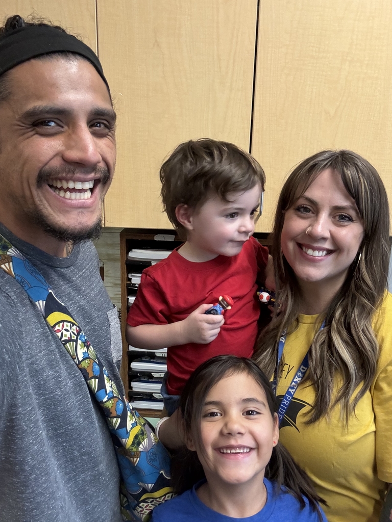 Family smiling as they meet teachers and staff at back to school night