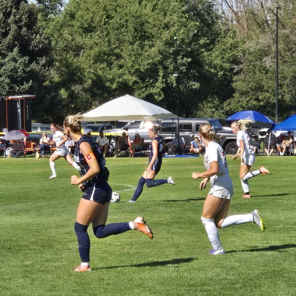 soccer players kicking the ball