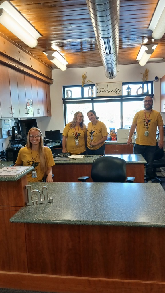 Office staff posing and smiling in our office  ready to support our students.