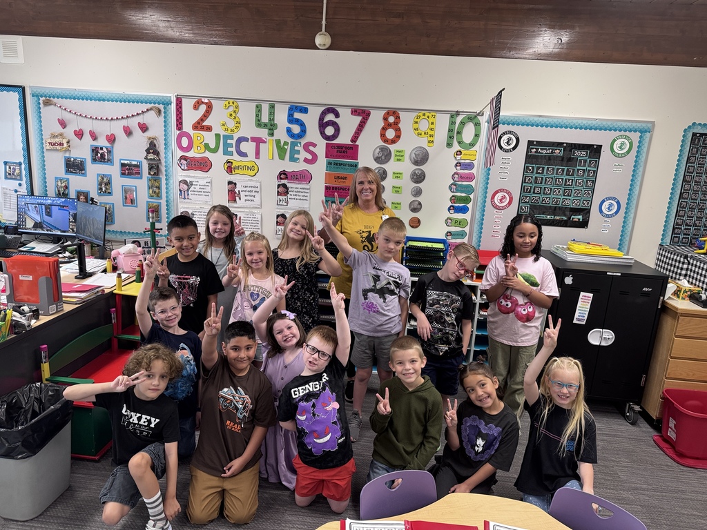 Mrs. Mitchells' 2nd grade class posing together in their new classroom