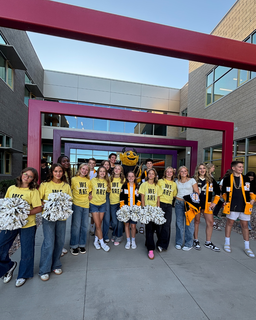 Sunset Junior High Cheerleaders and Student Government smile at the camera.