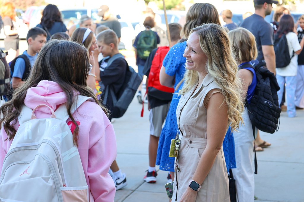 a principal laughing with a student.