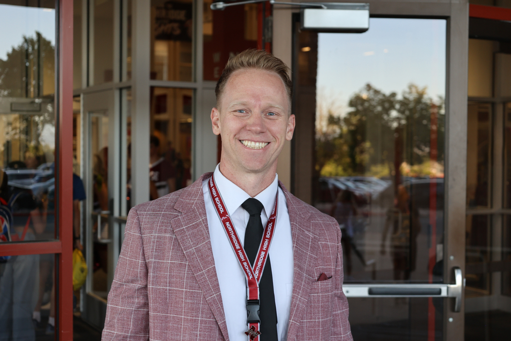 A principal smiling.