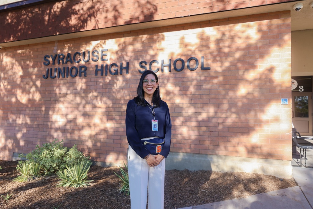a principal smiling.