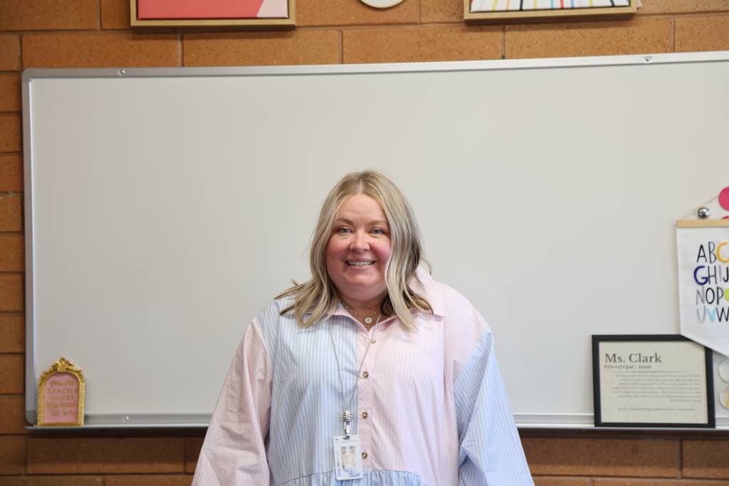 a principal smiling.