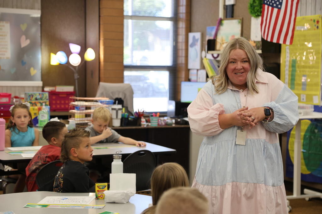a principal talking with a class of students.